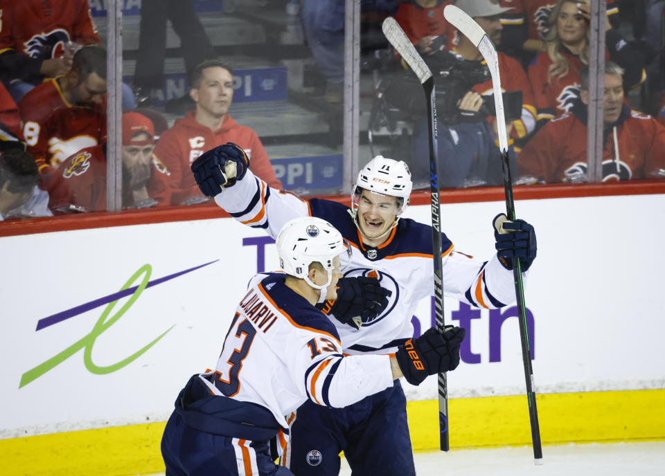 Edmonton Oilers winger Jesse Puljujarvi, left, celebrates his goal against the Calgary Flames with center Ryan McLeod during the second period of Game 5 of an NHL hockey second-round playoff series Thursday, May 26, 2022, in Calgary, Alberta. (Jeff McIntosh/The Canadian Press via AP)