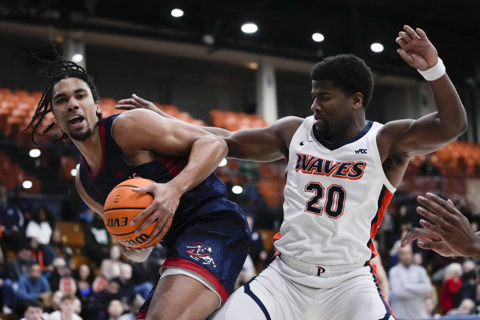 Saint Mary's forward Mason Forbes, left, and Pepperdine guard Ethan Anderson vie for the ball during the first half of an NCAA college basketball game Thursday, Feb. 29, 2024, in Malibu, Calif. (AP Photo/Ryan Sun)