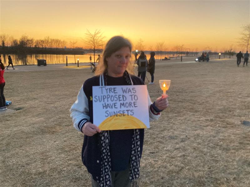 Kimberly Baker, a mother, holds her sign at the Feb. 5 Tyre Nichols vigil. The sign reads "Tyre was supposed to have more sunsets."