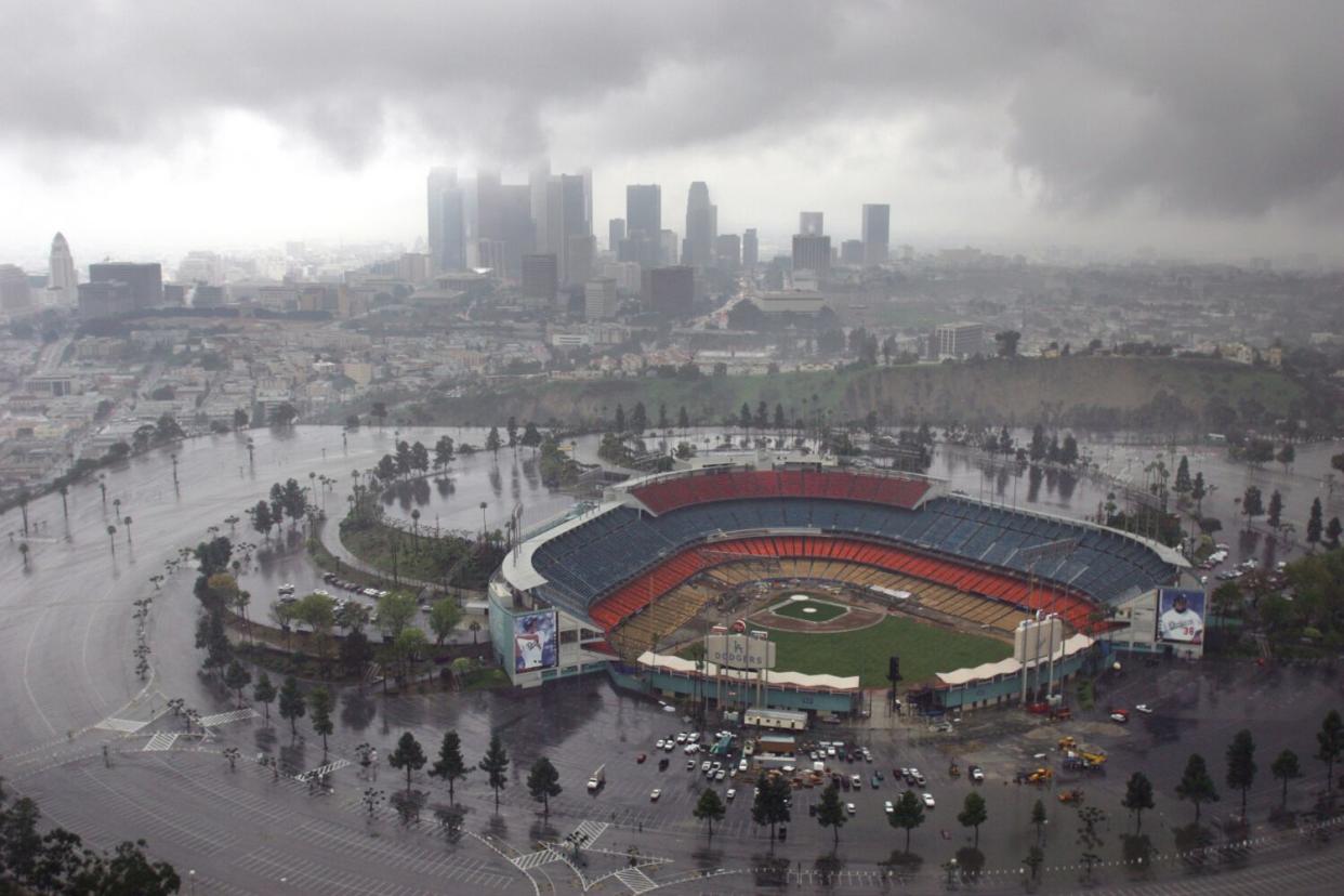 Dodger Stadium is surrounded by wet pavement after a storm.