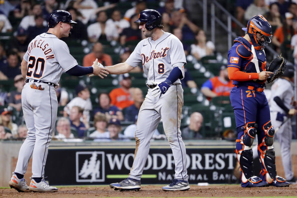 CORRECTS TO 11TH INNING INSTEAD OF 10TH INNING - Detroit Tigers' Spencer Torkelson (20) and Matt Vierling (8) celebrate behind Houston Astros catcher Martin Maldonado, right, after they scored on a two-run home run by Vierling during the 11th inning of a baseball game, Monday, April 3, 2023, in Houston. (AP Photo/Michael Wyke)