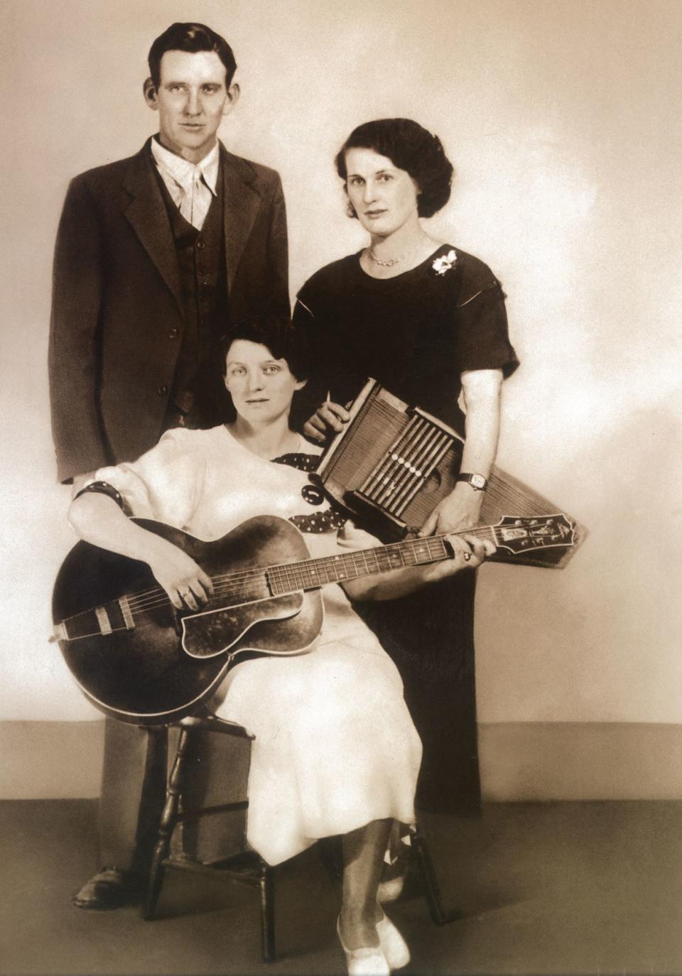 The original Carter Family band  in 1930. (from left) A.P., Maybelle  with her Gibson L-5, and Sara