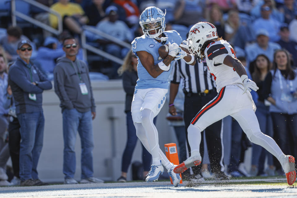 North Carolina wide receiver Chris Culliver (3) catches a touchdown pass ahead of Campbell cornerback Ronald Bullard (26) in the second half of an NCAA college football game in Chapel Hill, N.C., Saturday, Nov. 4, 2023. North Carolina won 59-7. (AP Photo/Nell Redmond)