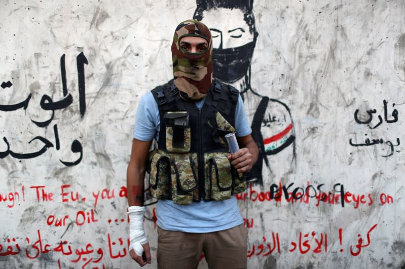 Hussein Karim Hashem, an Iraqi demonstrator, poses for a photograph during the ongoing anti-government protests in Baghdad