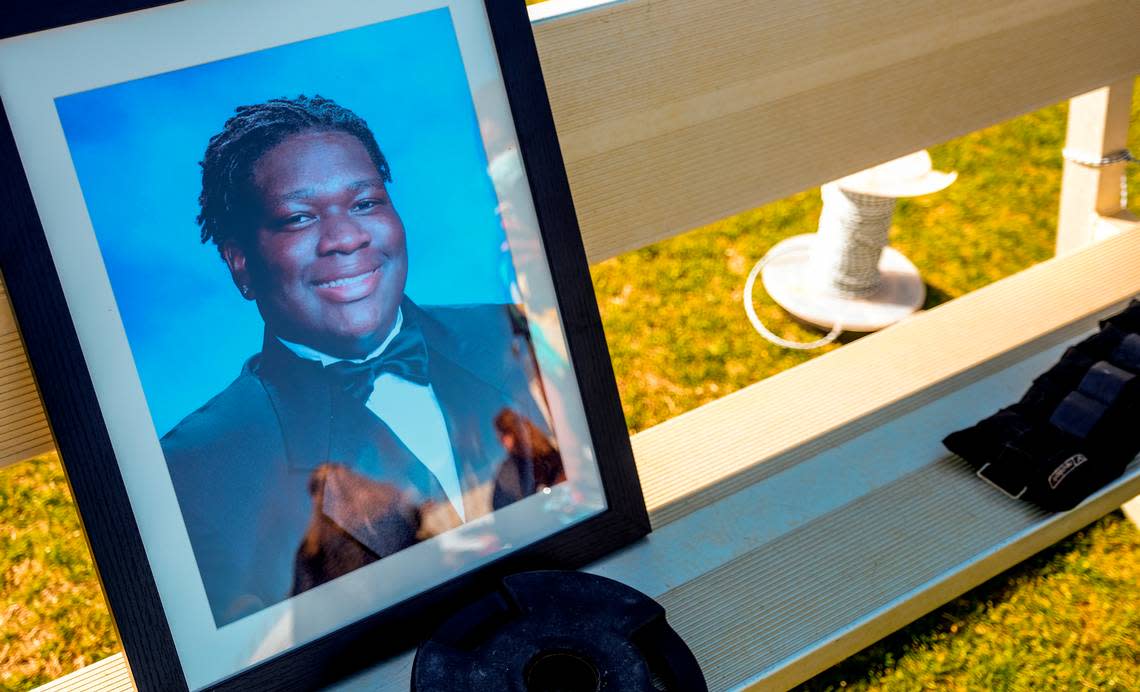 Photos of senior Dwon “DJ” Fields Jr. were placed on a bench during a public vigil on Sunday, March 7, 2021 at Bluffton High School.