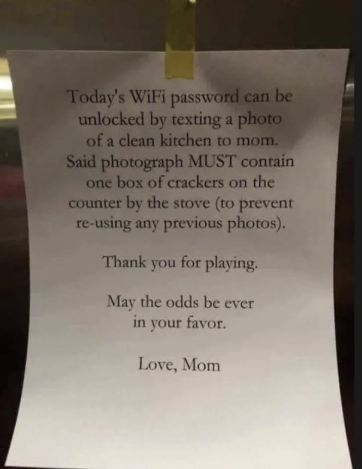 Note taped to a surface reads: "Today's WiFi password can be unlocked by texting a photo of a clean kitchen to mom. Include one box of crackers by the stove. Love, Mom."