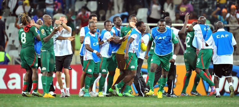 Burkina Faso's players celebrate beating Ghana on penalties on February 6, 2013 in Nelspruit. Burkina Faso drew with Nigeria in a Group C opener before whipping Ethiopia, holding title-holders Zambia and edging Togo through an extra-time goal and Ghana on penalties