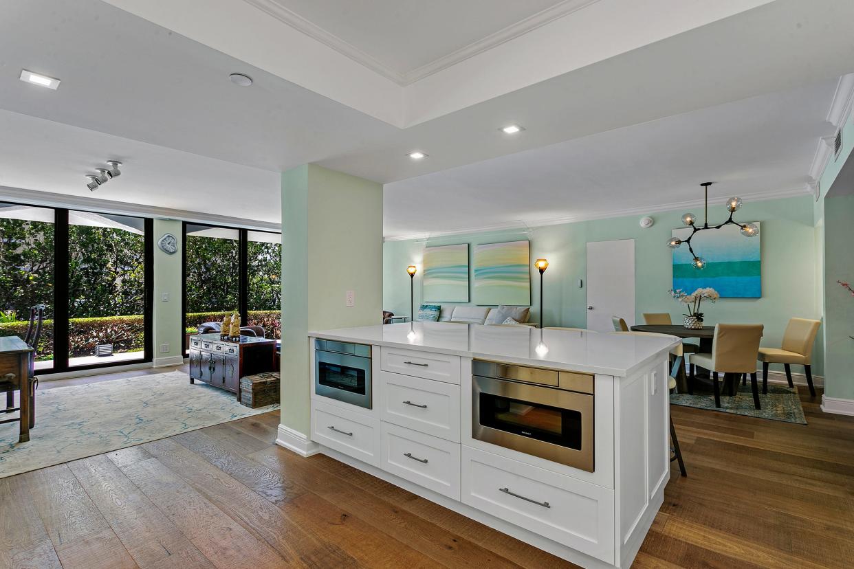 Appliances are set into the counter that separates the kitchen from the dining area.