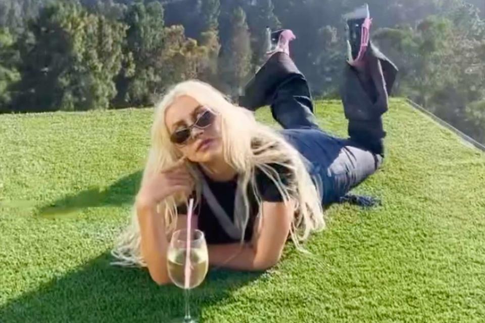 <p>Christina Aguilera/Instagram</p> Christina Aguilera poses in a new behind-the-scenes Instagram video of a photo shoot.