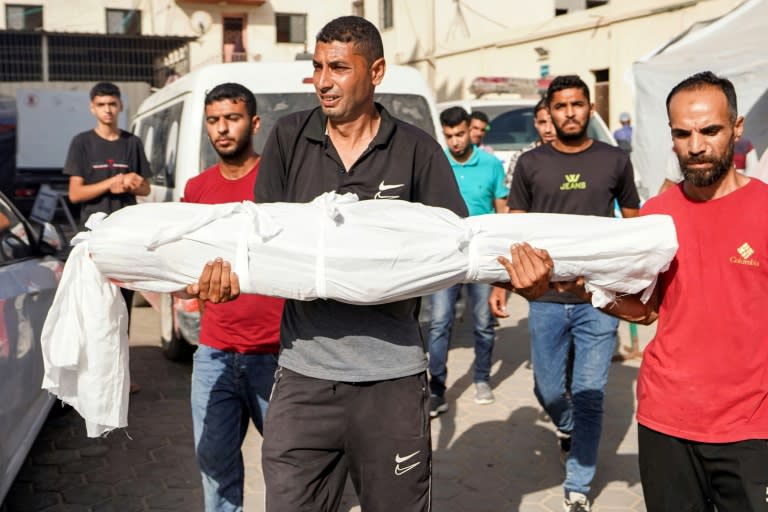 Un hombre lleva el cuerpo de Abdelrahman Yussef Abu Galambo, un niño de 11 años que murió durante un bombardeo israelí en al Bureij, en el centro de la Franja de Gaza (-)