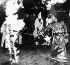 <p>An unidentified member of the Ku Klux Klan lights a cross during a rally in Braddock Heights, Maryland, Saturday, July 25, 1981. (Photo: Tom Yeatman/AP) </p>