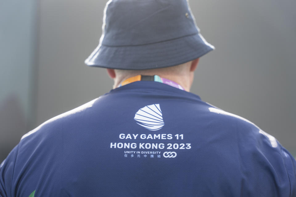 A participant wears a shirt with the Gay Games logo as he attends the AIDS Quilt Memorial Ceremony, ahead of the Gay Games in Hong Kong, Saturday, Nov. 4, 2023. The first Gay Games in Asia are fostering hopes for wider LGBTQ+ inclusion in the regional financial hub, following recent court wins in favor of equality for same-sex couples and transgender people. (AP Photo/Chan Long Hei)