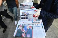 <p>A South Korean newspaper deliveryman collects newspapers in Seoul reporting the summit between President Donald Trump and North Korean leader Kim Jong Un on June 12, 2018. (Photo: Jung Yeon-je/AFP/Getty Images) </p>