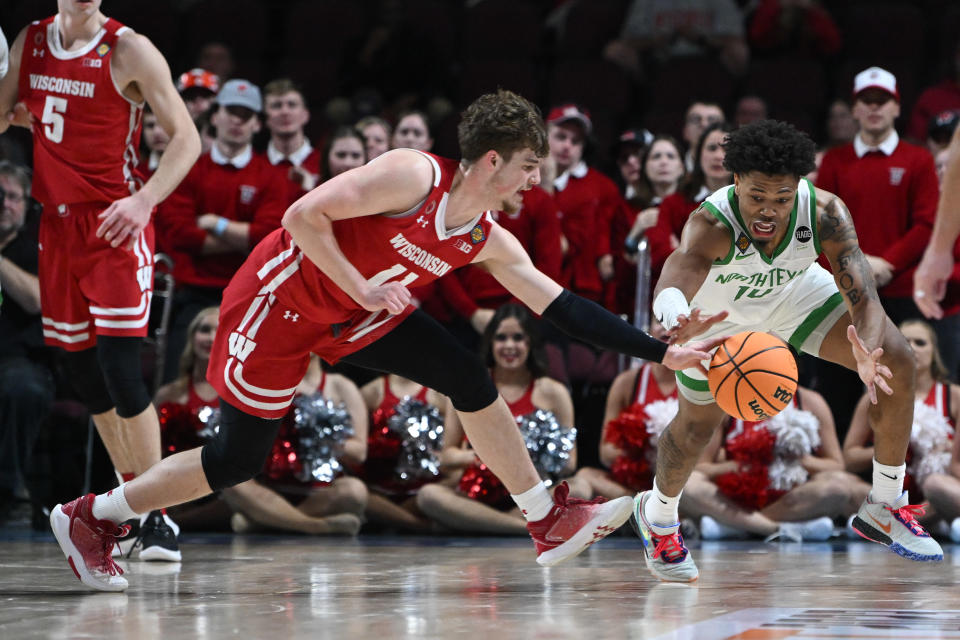 Mar 28, 2023; Las Vegas, NV, USA; Wisconsin Badgers guard Max Klesmit (11) and North Texas Mean Green guard Kai Huntsberry (10) compete for a loose ball in the second half at Orleans Arena. Mandatory Credit: Candice Ward-USA TODAY Sports