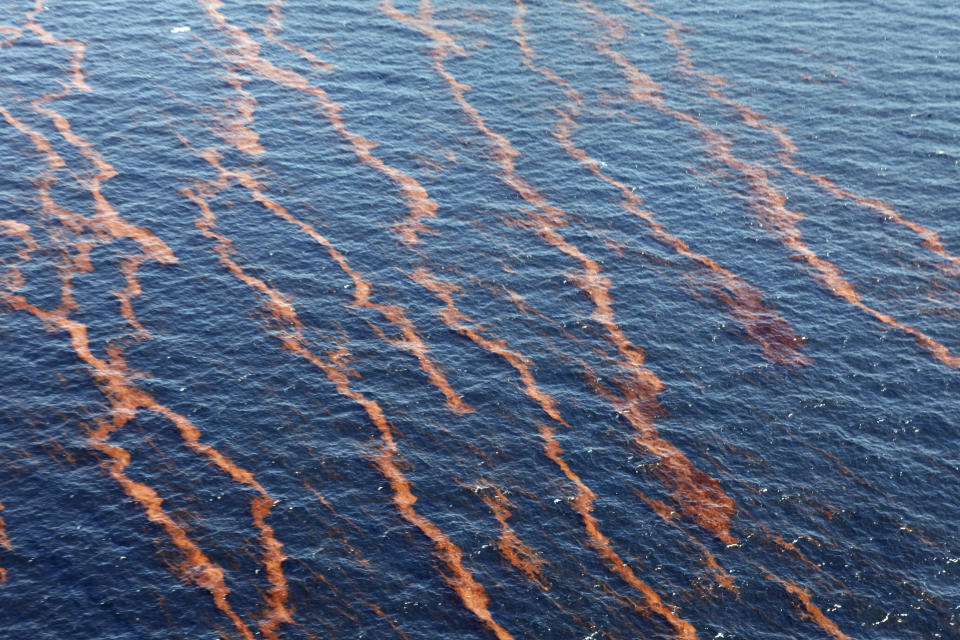 FILE - In this Monday, April 26, 2010, aerial file photo taken over the Gulf of Mexico, weathered oil is seen near the coast of Louisiana from a leaking pipeline that resulted from the explosion and collapse of the Deepwater Horizon oil rig a week earlier. Environmental groups have asked a federal court to toss out the government's assessment of oil and gas activity's likely effects on endangered species in the Gulf of Mexico. A lawsuit filed Wednesday, Oct. 21, 2020, says the report doesn’t consider the likelihood of another catastrophic oil spill like BP's Deepwater Horizon spill of 2010. (AP Photo/Gerald Herbert, File)