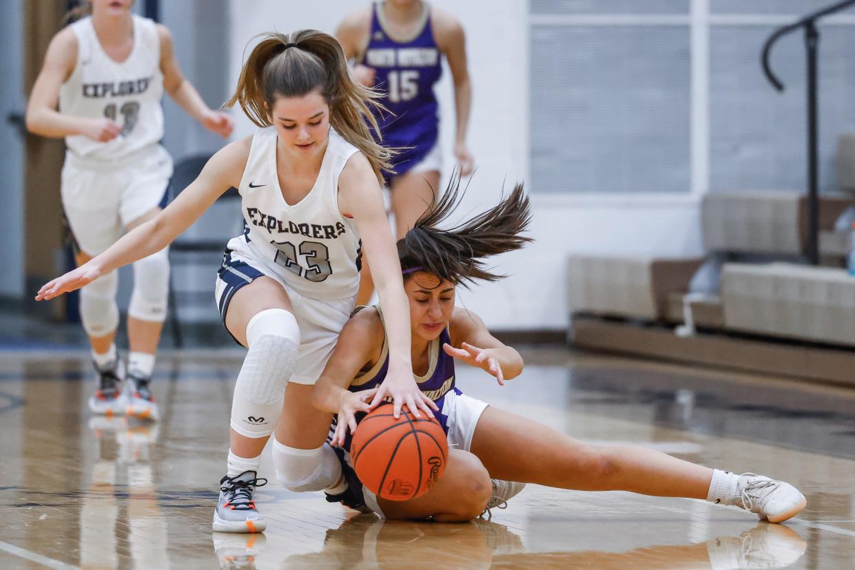 Hudson's Madi Kordos fights North Royalton's Antonella Palmerio  for a loose ball during the Explorers' 57-35 home win over the Bears Dec. 1.