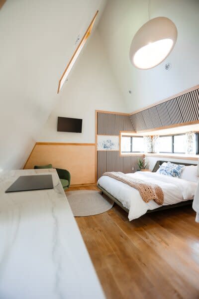 Inside, the one-bedroom cabins include kitchenettes and a neutral palette. The site also offers a communal sauna, a pickleball court, and bike rentals.