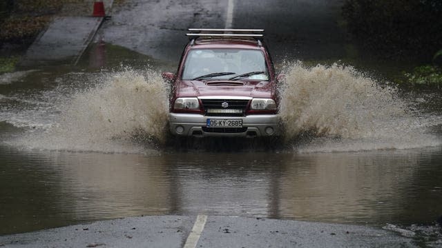 Car drives through floodwater