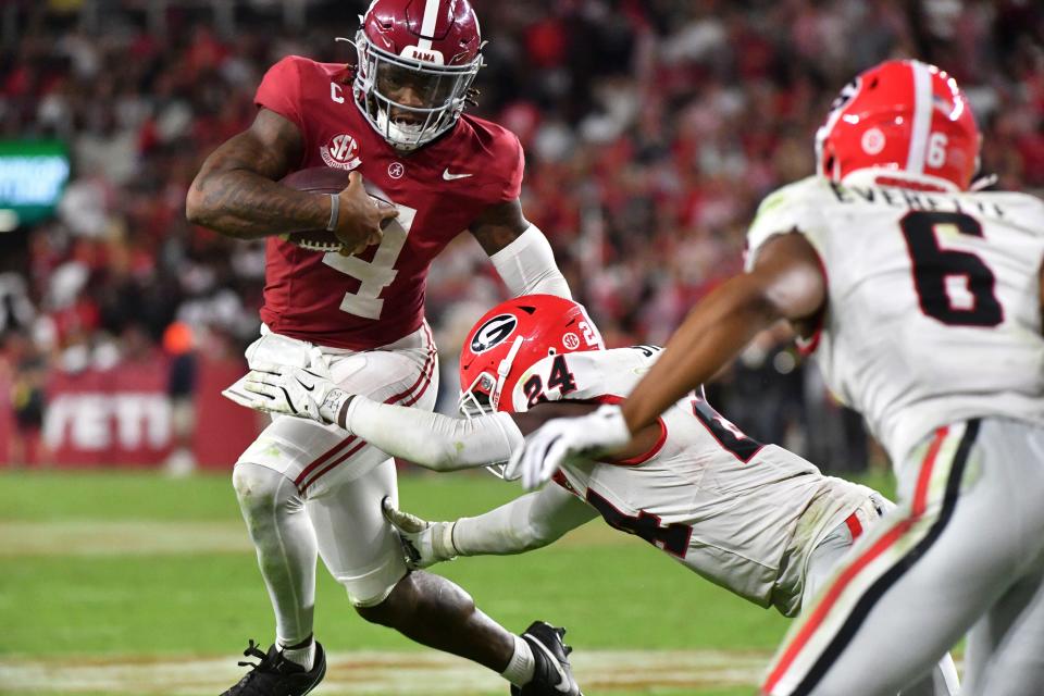 Sep 28, 2024; Tuscaloosa, Alabama, USA; Georgia Bulldogs defensive back Malaki Starks (24) makes a tackle on Alabama Crimson Tide quarterback Jalen Milroe (4) at Bryant-Denny Stadium. Alabama defeated Georgia 41-34. Mandatory Credit: Gary Cosby Jr.-Imagn Images