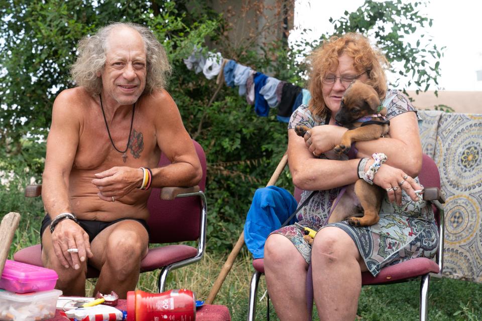 Jeffery Buddenhagen and his fiancee, Patsy Kerbo, pose Friday with their little dog, Rosie, at their campsite near the Topeka Rescue Mission.