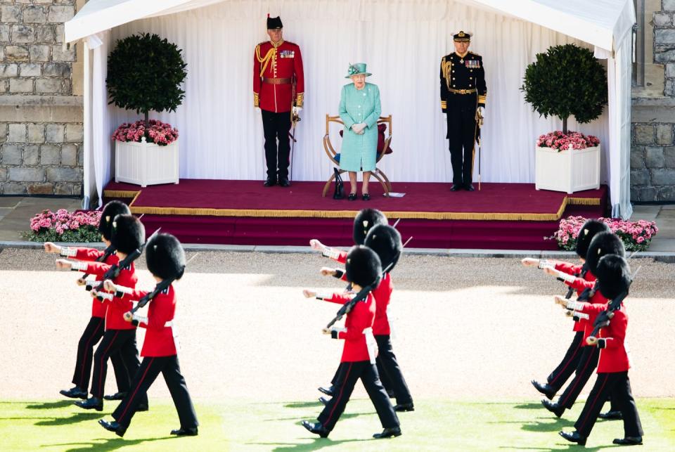 <p>Queen Elizabeth watches the private parade from afar. </p>