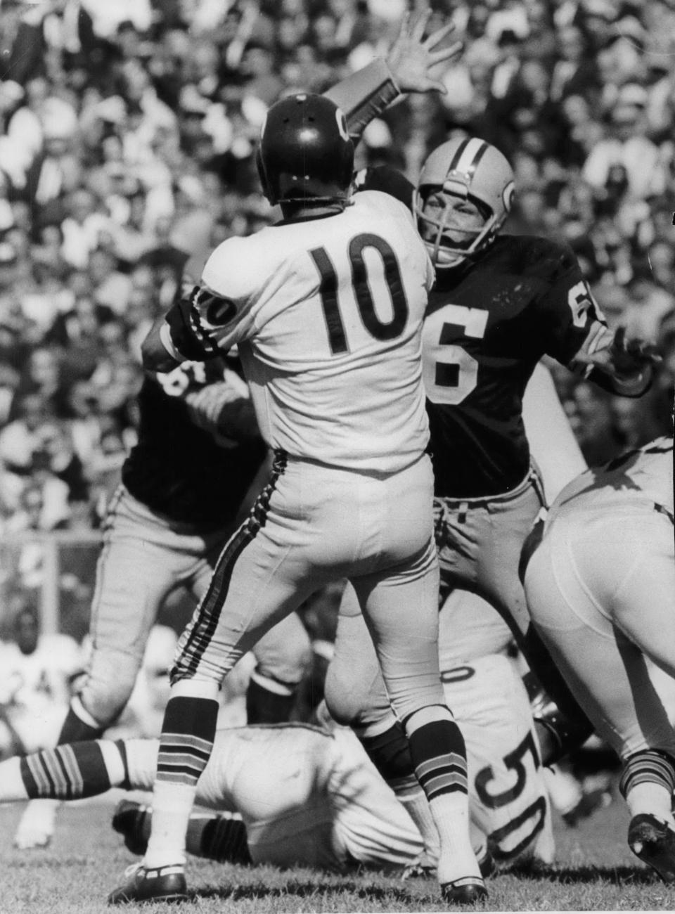 Packers middle linebacker Ray Nitschke blitzes Rudy Bukich of the Chicago Bears during the 1964 season opener in Green Bay.