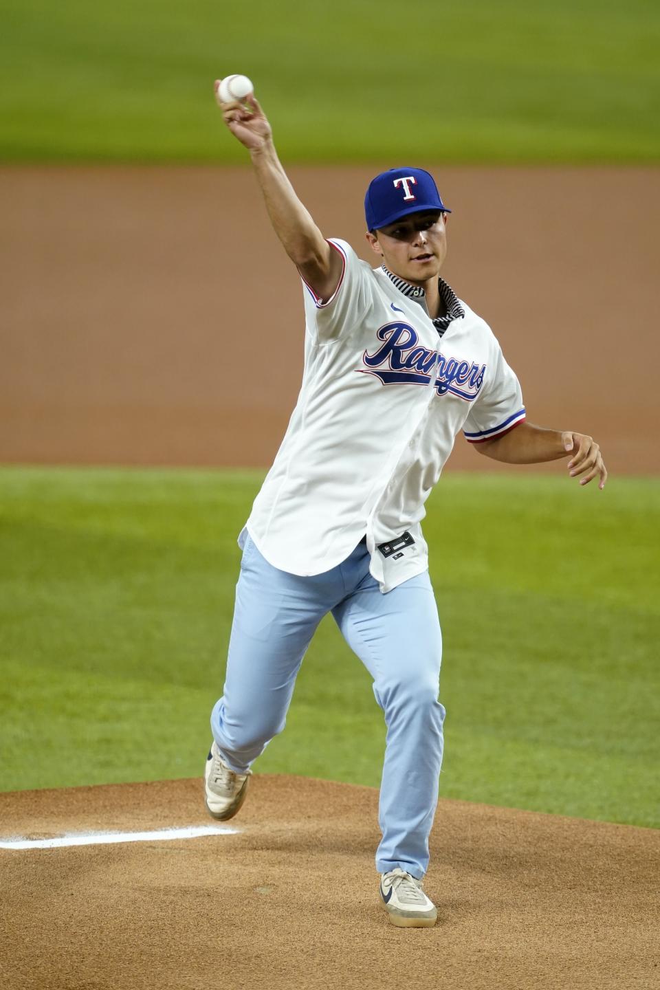 Texas Rangers first-round draft pick Jack Leiter throws out the ceremonial first pitch before the Rangers' baseball game against the Arizona Diamondbacks in Arlington, Texas, Wednesday, July 28, 2021. (AP Photo/Tony Gutierrez)