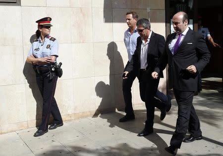Jorge Horacio Messi (2nd R), father of Barcelona's soccer player Lionel Messi, leaves after answering charges of tax evasion in the court in Gava September 27, 2013. REUTERS/Albert Gea