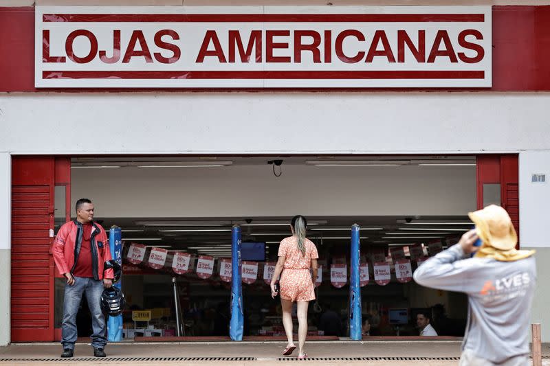 FILE PHOTO: People walk in front of a Lojas Americanas store in Brasilia