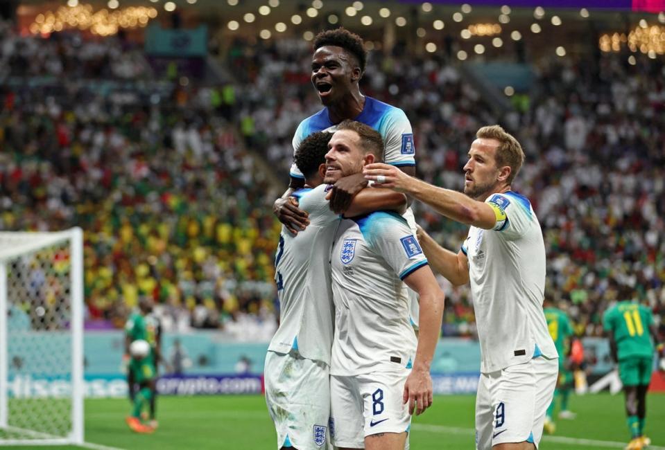 The squad celebrates Henderson’s goal (Reuters)