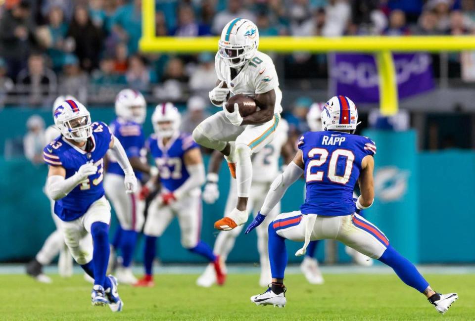 Miami Dolphins wide receiver Tyreek Hill (10) catches the ball as Buffalo Bills safety Taylor Rapp (20) looks to tackle in the second quarter of an NFL game at Hard Rock Stadium on Sunday, Jan. 7, 2023, in Miami Gardens Fla. MATIAS J. OCNER/mocner@miamiherald.com