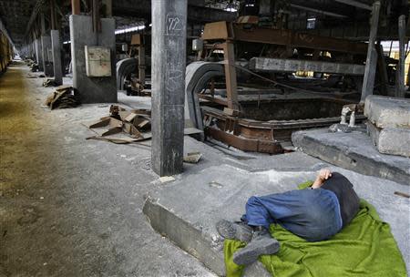 An employee takes a nap in a shutdown electrolysis plant in Montenegro's Kombinat Aluminijuma Podgorica (KAP) aluminium factory in Podgorica September 9, 2013. REUTERS/Stevo Vasiljevic