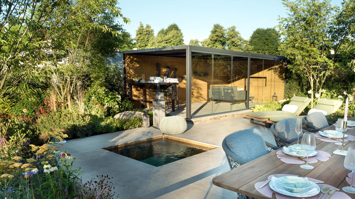  paved backyard area with water feature and garden room 