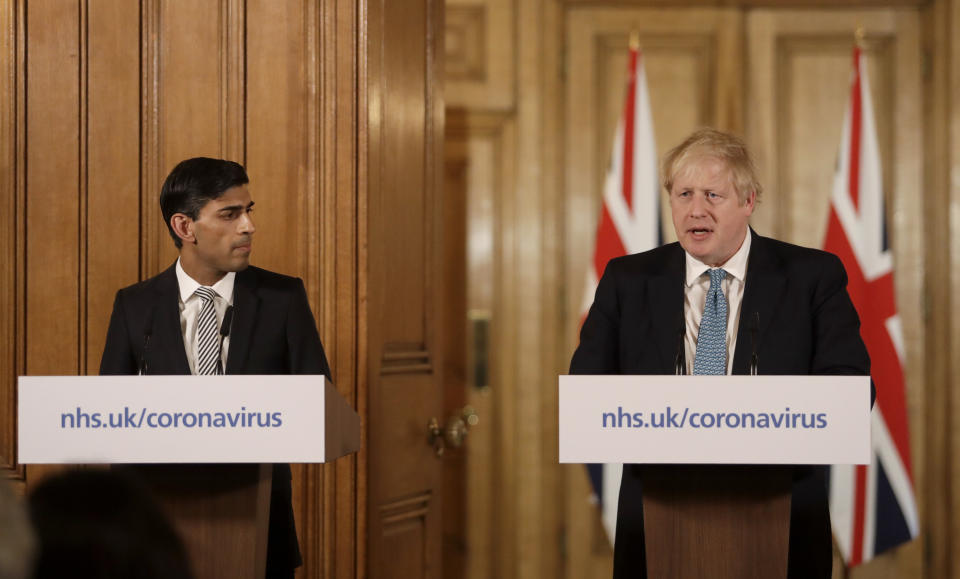 LONDON, ENGLAND - MARCH 17: Britain's Chancellor Rishi Sunak, (L) and British Prime Minister Boris Johnson give a press conference about the ongoing situation with the coronavirus (COVID-19) outbreak inside 10 Downing Street on March 17, 2020 in London, England. For most people, the new coronavirus causes only mild or moderate symptoms, such as fever and cough. For some, especially older adults and people with existing health problems, it can cause more severe illness, including pneumonia. (Photo by Matt Dunham - WPA Pool/Getty Images)