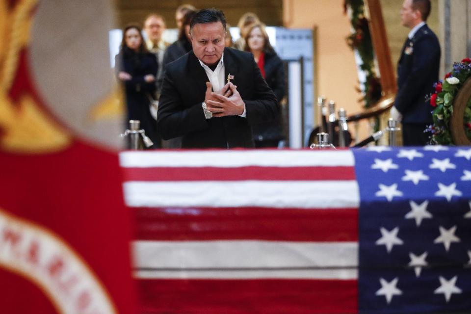 Mourners arrive to view the casket of John Glenn as he lies in repose, Friday, Dec. 16, 2016, in Columbus, Ohio. Glenn, 95, the first American to orbit Earth, died last week. (AP Photo/John Minchillo)