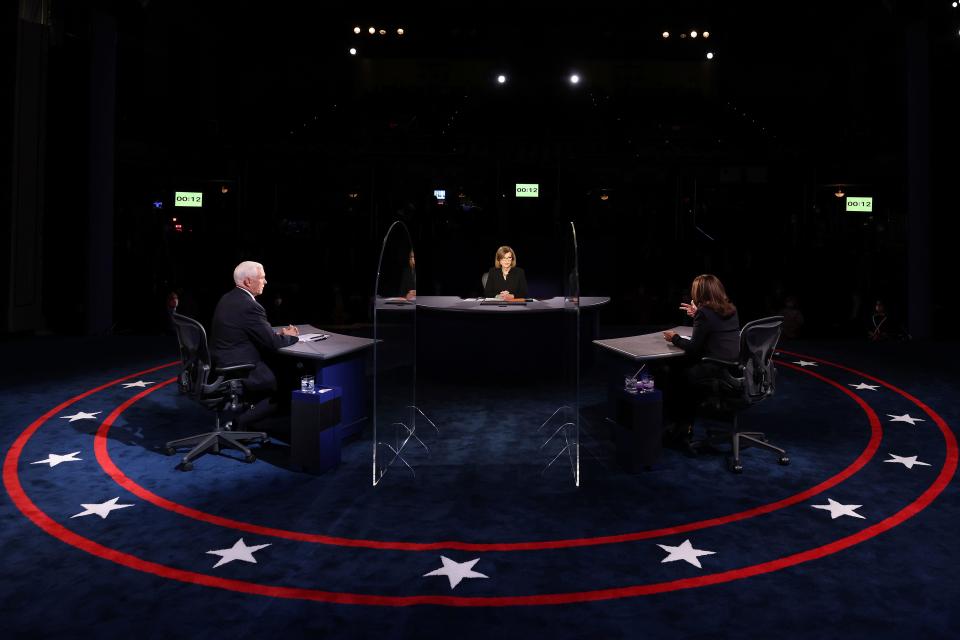 Vice President Mike Pence listens as Democratic vice presidential candidate Sen. Kamala Harris, D-Calif., speaks during the vice presidential debate Wednesday, Oct. 7, 2020, at Kingsbury Hall on the campus of the University of Utah in Salt Lake City. (Justin Sullivan/Pool via AP)