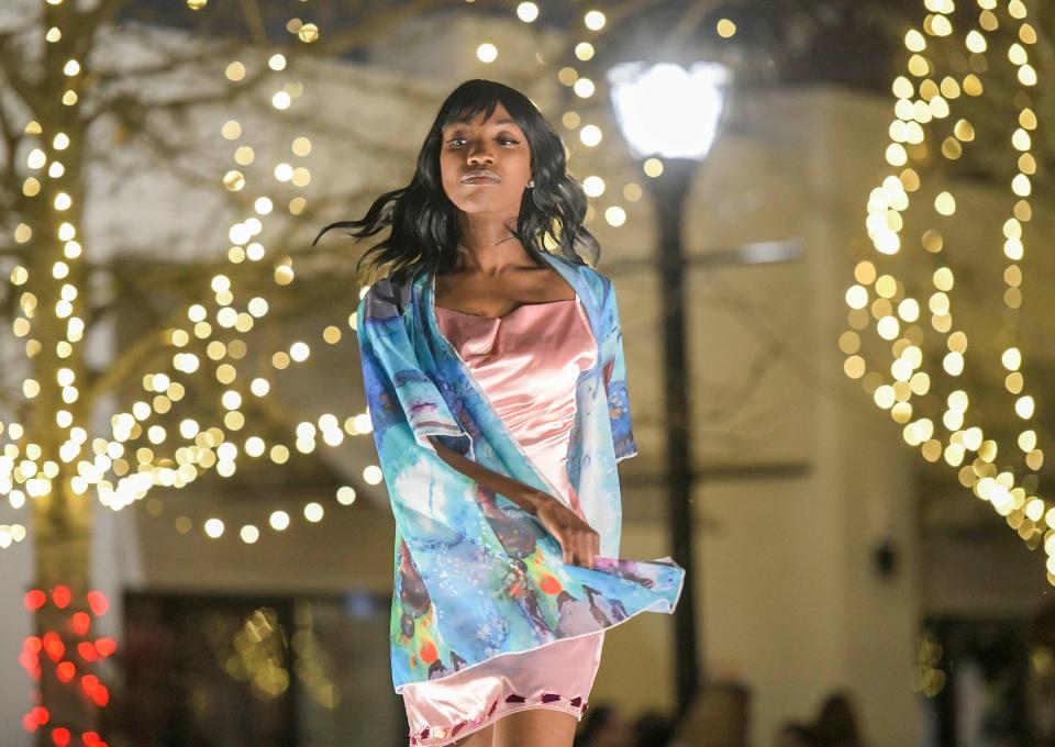 A model walks the runway wearing Art 4 Wear clothes during a during a fashion show held outside The Finishing Touch Boutique in downtown Eustis on Friday, March 4, 2022. [PAUL RYAN / CORRESPONDENT]