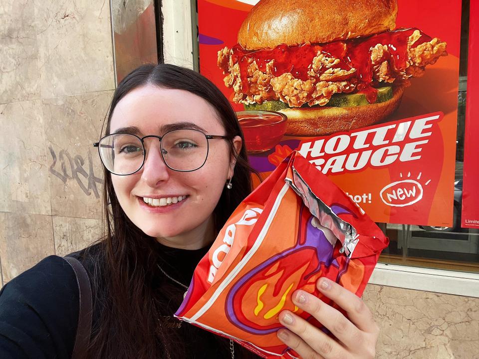 author holding megan thee stallion popeyes chicken sandwich