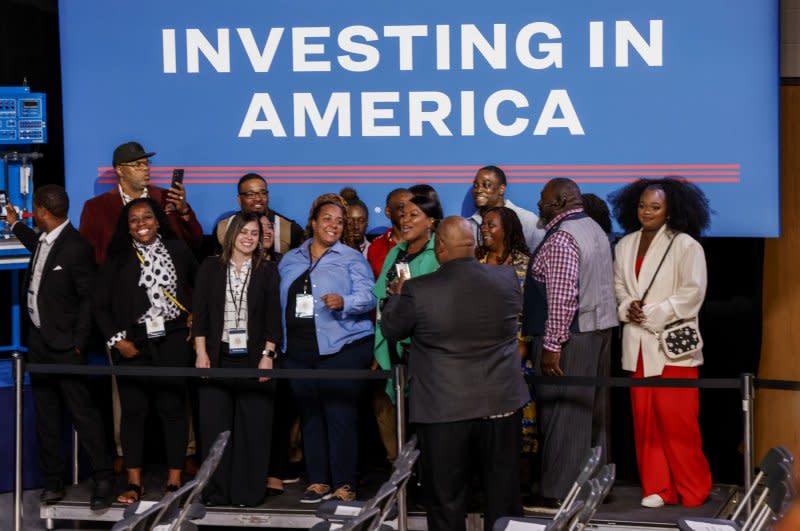 People pose for photos as they wait for U.S. President Joe Biden to speak at Gateway Technical College in Sturtevant, Wisc., on Wednesday. “So far we've created $866 billion in private sector investment nationwide,” Biden said. Photo by Tannen Maury/UPI