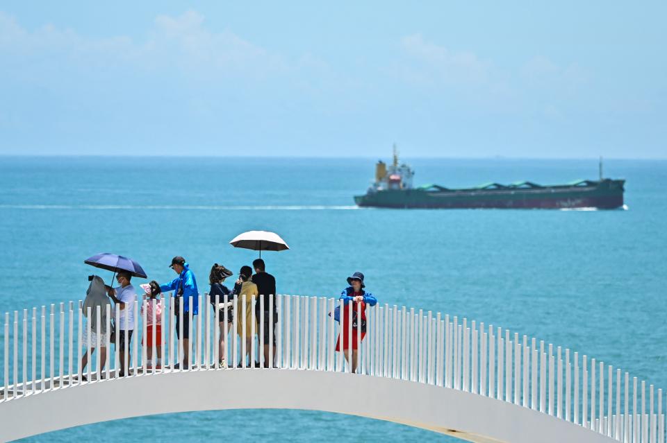 Tourists visit a scenic area on Pingtan island, one of mainland China’s closest point from Taiwan, in Fujian province on 5 August 2022 (AFP via Getty Images)