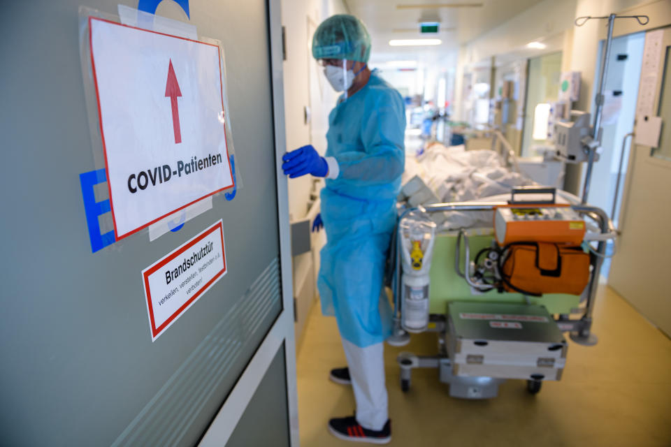 LEIPZIG, GERMANY - NOVEMBER 18: A doctor tends to a patient in the Covid-19 intensive care unit at University Hospital Leipzig on November 18, 2021 in Leipzig, Germany. Hospitals are coping with a high influx of patients as the fourth wave of the coronavirus pandemic is sending infection rates to new record highs in Germany. Saxony is especially hard hit, with an average of over 750 new cases per 100,000 over a seven-day period, the highest for any state nationwide. Germany's vaccination rate, currently at about 67% of the population, is low compared to many other EU countries. The vast majority of people currently being admitted to hospital with Covid are unvaccinated. (Photo by Jens Schlueter/Getty Images)