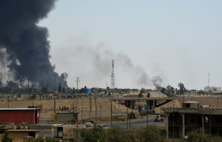 A general view shows smoke billowing from the Qayyarah on August 24, 2016, as Iraqi forces took key positions in the centre of the city, officials said, on the second day of an operation to recapture the northern town from jihadists