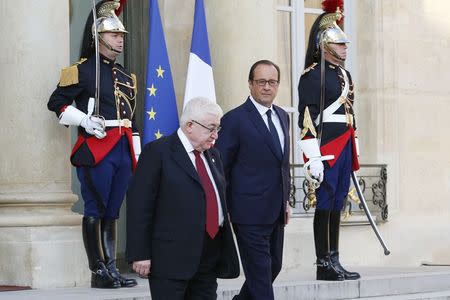 French President Francois Hollande (R) walks with Iraq's President Fuad Masum after a meeting the Elysee Palace in Paris September 15, 2014, ahead of a conference bringing together about 30 countries to discuss how to cooperate in the fight against Islamic State militants. REUTERS/John Schults