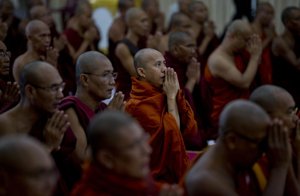 In this Thursday, June 13, 2013 photo, controversial Buddhist monk Wirathu, center, who is accused of instigating sectarian violence between Buddhists and Muslims through his sermons, performs Buddhist rituals during an assembly of Myanmar’s powerful Buddhist clergy in Hmawbi, outskirts of Yangon, Myanmar. Wirathu is a charismatic speaker and supporter of the fundamentalist 969 movement. His following is growing as he crisscrosses the country calling for boycotts of Muslim-owned shops and a ban on marriages between Buddhist women and Muslim men, and warning that a higher birthrate could one day bring Muslims from 4 percent of the population to a majority. (AP Photo/Gemunu Amarasinghe)