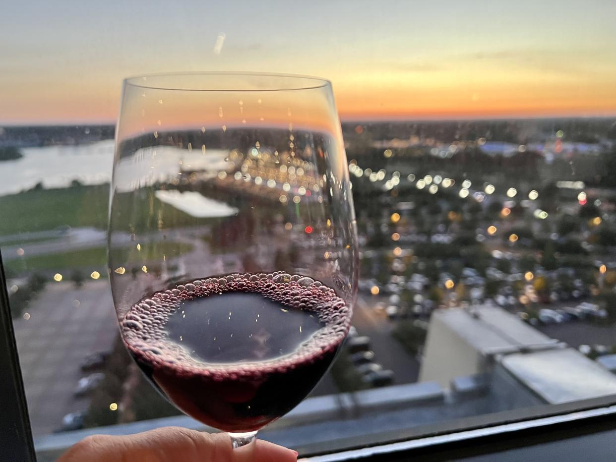 The sun set over the Seven Seas Lagoon and Magic Kingdom Park as I sipped my perfectly-paired Cabernet. (Photo: Terri Peters)