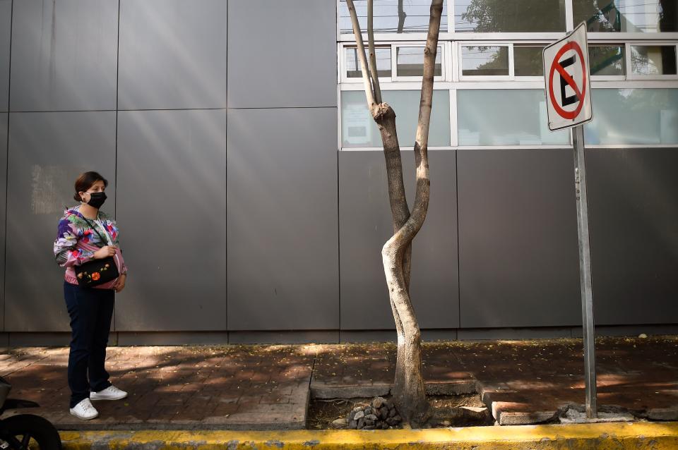 A pregnant woman stays outside the Tacuba General Hospital in Mexico City on April 21, 2020. - Mexico raised its health emergency level following a rapid increase in coronavirus cases and amid fears the health system could collapse, the government said Tuesday. (Photo by ALFREDO ESTRELLA / AFP) (Photo by ALFREDO ESTRELLA/AFP via Getty Images)