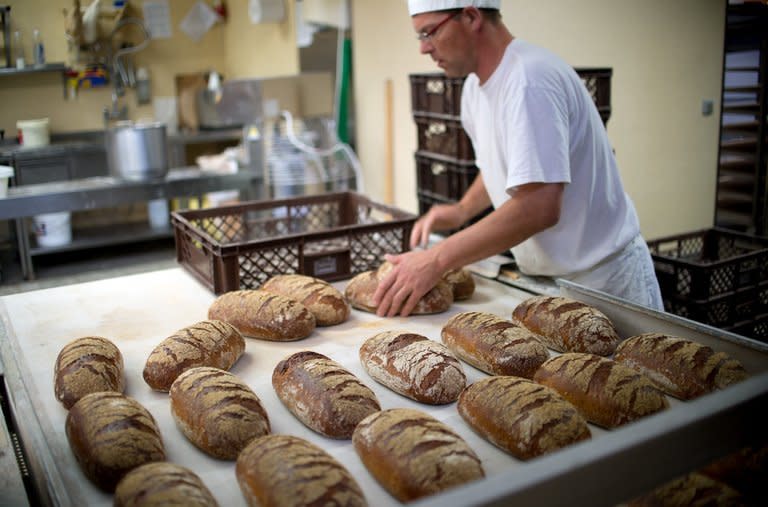 Master baker Steffen Haensch takes fresh potato bread out of the oven at Plentz bakery on July 1, 2013. The 'potato bread' is one of German master baker Karl-Dietmar Plentz's specialities that is still partly made the way his grandfather did it