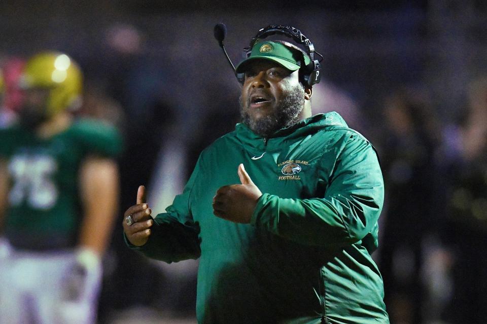 Fleming Island football coach Damenyum Springs calls out instructions during a game against Oakleaf.