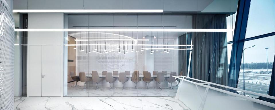 A conference room inside the new lounge features a relief of Gagarin's face, space-age pendant lights, and a shiny reflective tabletop. 