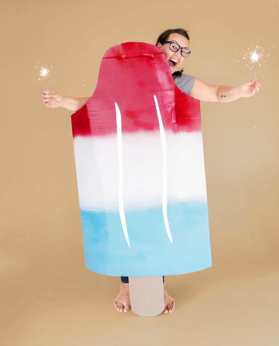 <p>As sweet (and low effort) as the lazy days of summer, this costume calls for large pieces of cardboard; red, white, and blue spray paint; and white acrylic paint. (Sparklers optional!)<br><br><strong>Get the tutorial at <a href="https://ohyaystudio.com/how-to-make-an-easy-bomb-pop-popsicle-costume/" rel="nofollow noopener" target="_blank" data-ylk="slk:Oh Yay Studio;elm:context_link;itc:0;sec:content-canvas" class="link ">Oh Yay Studio</a>.</strong></p>